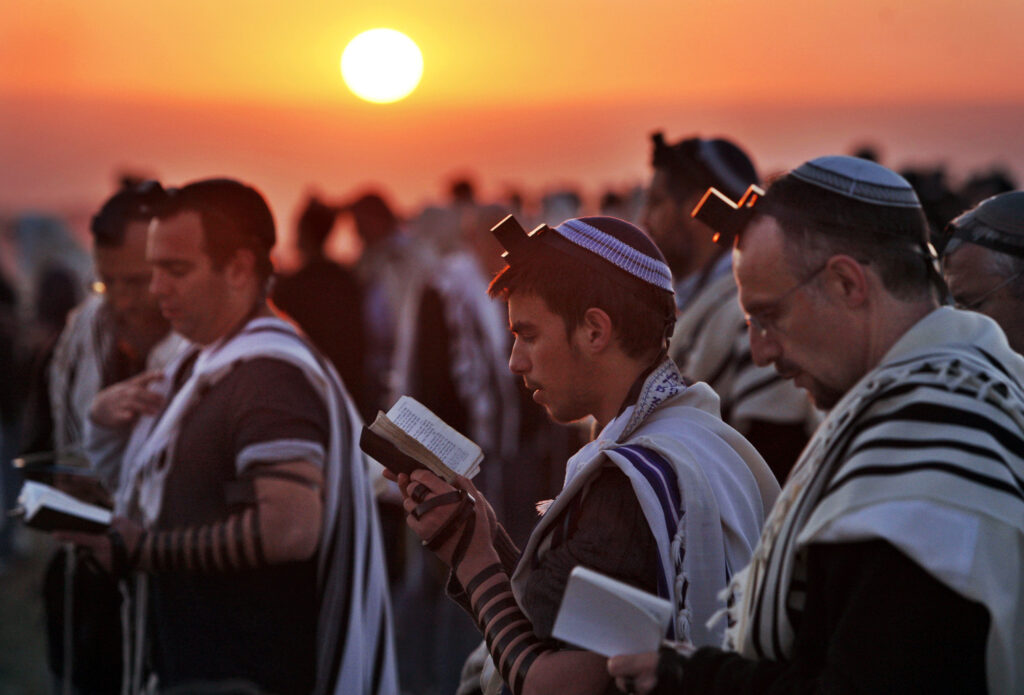 Jewish worshippers wrapped in prayer shawls, participate in the special "Blessing of the Sun" prayer at sunrise on the Eitam Hilltop near the West Bank Jewish settlement of Efrata, Wednesday, April 8, 2009. Devout Jews around the world on Wednesday observed a ritual performed only once every 28-years, saying their morning prayers under the open sky in the "blessing of the sun", called the Birkat Hachamah in Hebrew. (AP Photo/Kevin Frayer)
